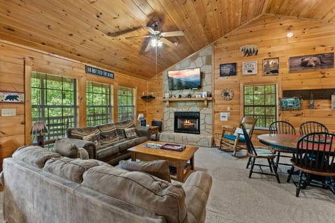 Snuggle up by the fire in this cozy living room, where bear-themed décor and soft seating invite you to relax after a day of Smoky Mountain adventures.