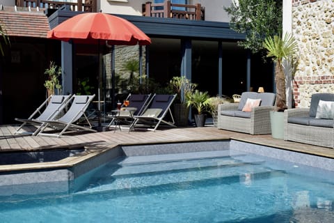 Seasonal outdoor pool, open 9:30 AM to 8:00 PM, pool umbrellas
