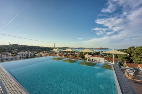 Seasonal outdoor pool, open 9:00 AM to 9:00 PM, pool umbrellas