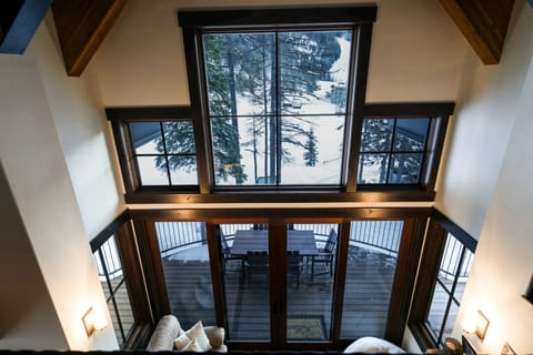 The cathedral ceiling and expansive windows enhance the beauty of the living space | Upper Level