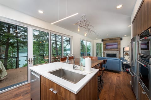 Prepare a meal while taking in the incredible views of Whitefish Lake | Main Floor