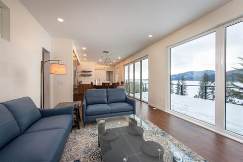 The Tree Haus living room features cozy seating and incredible views of Whitefish Lake | Main Floor