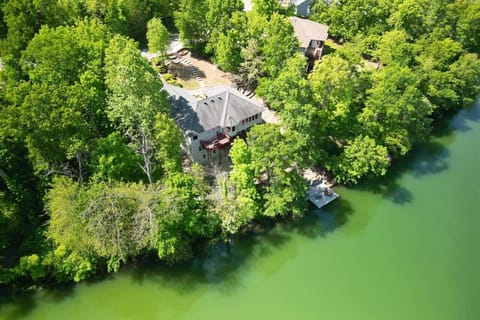 Drone shot capturing full property and dock along the shoreline—prime lakefront location.