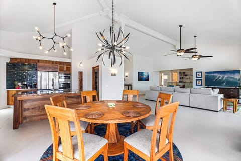 Stylish indoor dining beneath sculptural lighting, perfect for island-inspired meals and conversation that flows late into the evening.