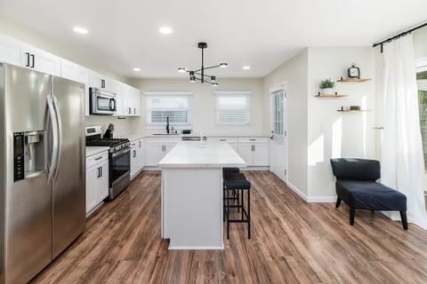 Bright modern kitchen with sleek white cabinets & center island