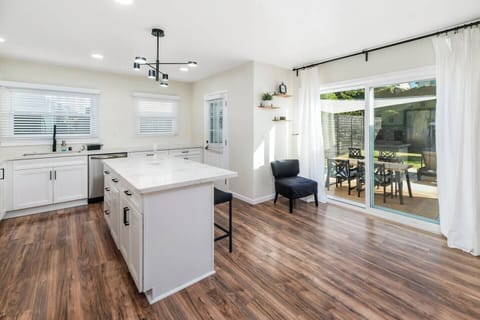 Sunlit kitchen with sleek finishes and seamless access to a patio dining area