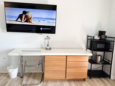 Well-equipped workspace and TV area inside the bedroom.