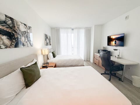 Spacious bedroom with balcony access and Smart TV.