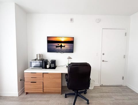 Well-equipped workspace and TV area inside the bedroom.