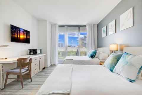 Bright and spacious bedroom with two double beds and natural light.