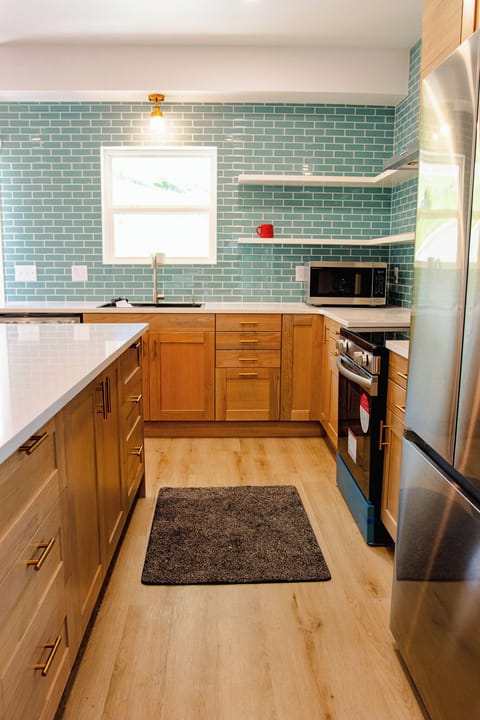 Large kitchen area with island and chairs