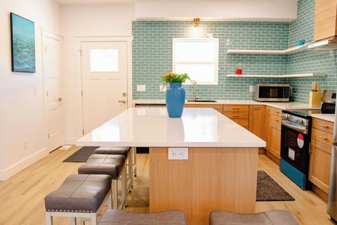 Large kitchen area with island and chairs