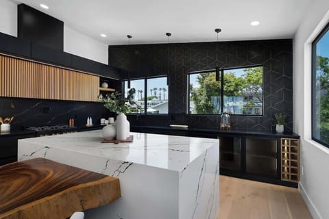 A sleek black kitchen, natural wood accents, and a waterfall island—this space is designed to impress. Add in that San Diego view, and it's pure perfection.