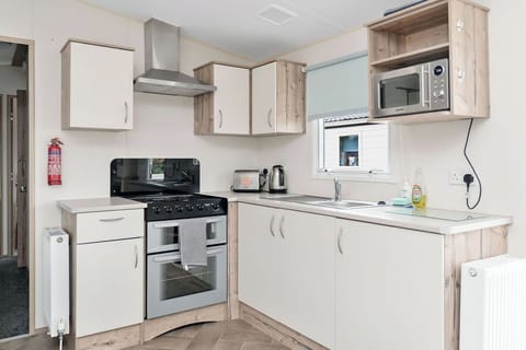 Modern kitchen with a gas stove, microwave, and ample storage—well-equipped for preparing meals with ease.