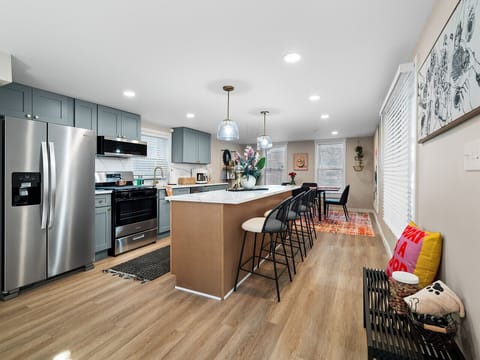 Spacious & stylish kitchen + dining ✨ Cook, sip, and socialize around the island or gather for meals at the colorful dining table! 🍷🍴