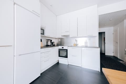 The apartment's kitchen is well-equipped and includes an oven, full-size fridge-freezer, stove, and dishwasher.