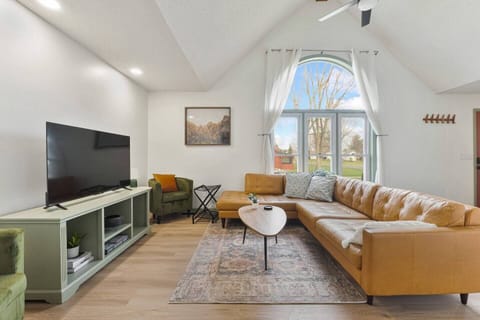 Stream your favorite movies on the large flat-screen TV in this open-concept living area. The mid-century modern layout ensures nobody misses out on the conversation.