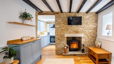 The inviting living room features a warming log burner