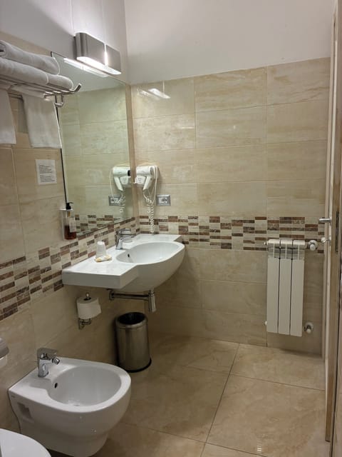 Deluxe Quadruple Room | Bathroom | Shower, hair dryer, towels, soap