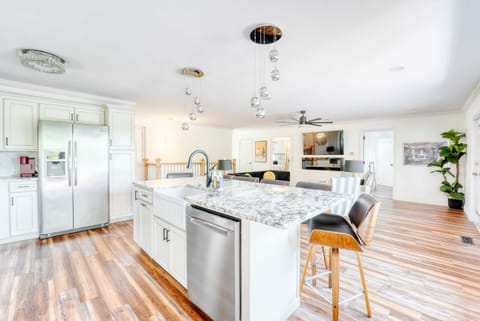 Spacious dining area and gourmet kitchen with island seating, stainless appliances and lake views—ideal for group meals.