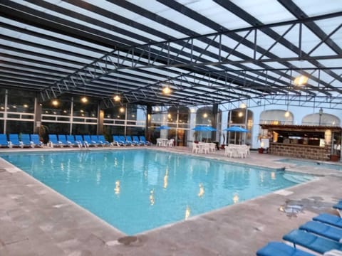 Indoor pool, open 8:00 AM to 8:00 PM, pool umbrellas, sun loungers