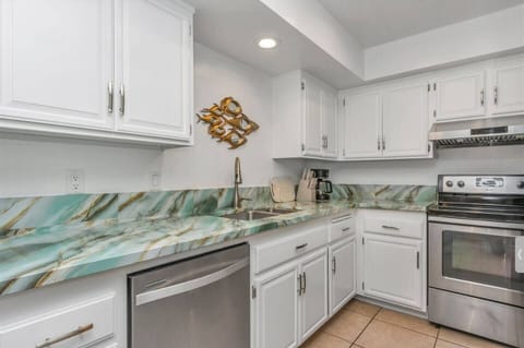 Fully equipped kitchen features all the essentials—including a large refrigerator, stove, microwave, dishwasher, coffee maker, complete cookware and plenty of dishes and glasses—perfect for preparing meals and enjoy it.
