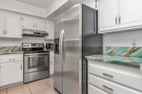 Fully equipped kitchen features all the essentials—including a large refrigerator, stove, microwave, dishwasher, coffee maker, complete cookware and plenty of dishes and glasses—perfect for preparing meals and enjoy it.