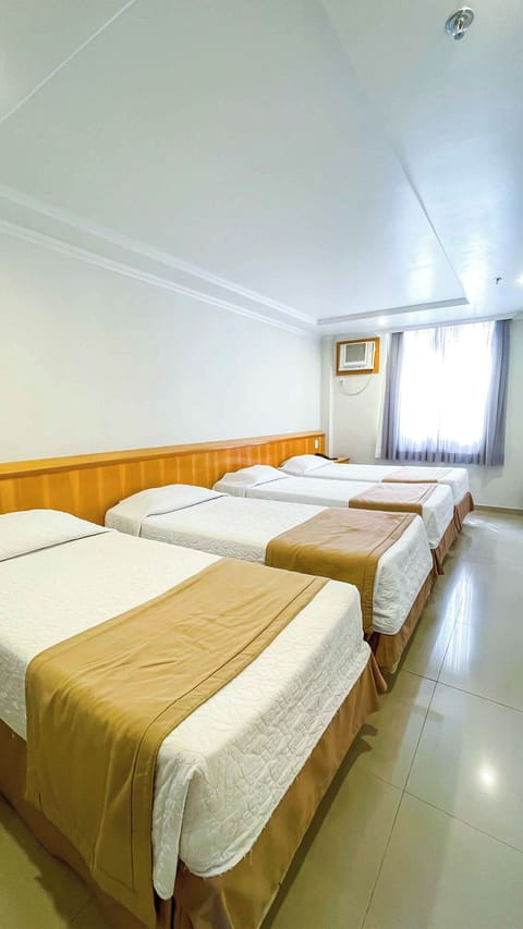 Family Quadruple Room | Minibar, in-room safe, desk, blackout drapes