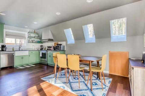 Cook, dine, and enjoy the bright, airy atmosphere! This open kitchen and dining area is perfect for your getaway.