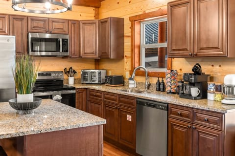 Kitchen with stainless steel appliances and all the essentials for home cooked meals.