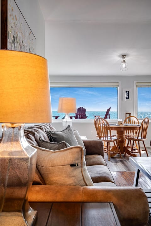 Sun-soaked living room with wall-to-wall lake views