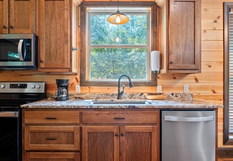 Enjoy the peaceful forest views as you prep meals or pour your morning coffee at this bright and beautiful kitchen window.