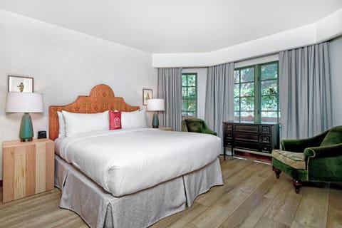Drift into crisp linens beside cozy reading chairs.