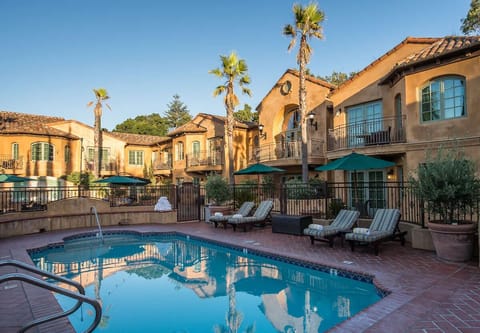 Lounge poolside with shaded umbrellas and plenty of seating.