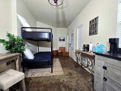 Bunk Room: Sleek bunks, modern kitchenette, and a welcoming vibe for your Fredericksburg getaway!