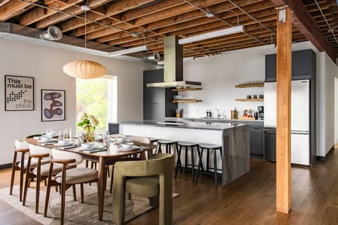 Sleek, modern kitchen with stainless steel appliances, island seating, and all the essentials for cooking or creating content.