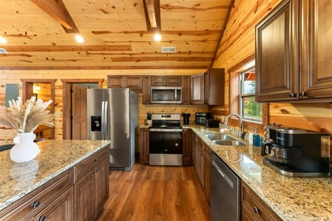 Kitchen with stainless steel appliances and all the essentials for home cooked meals. (House 1)