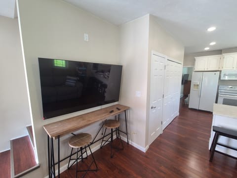 65" Smart TV + Wi-Fi & Snack Bar – Stream, Work, or Recharge in Comfort