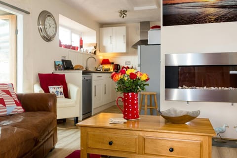 living room with leather sofa, wooden coffee table and wall integrated electric heater