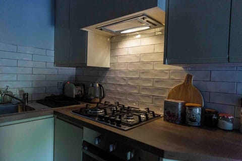 Compact kitchen with gas hob and fridge freezer, cupboards with full supply of kitchen ware. Coffee teas and herbs and spices for cooking supplied
