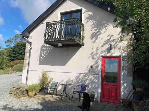 Entrance to apartment. Outdoor seating and table.