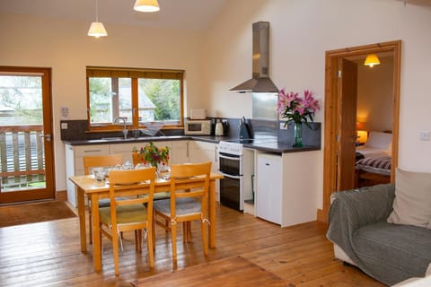Dining table laid for dinner and a vase of flowers