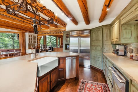 This modern Kitchen features stainless appliances, 6 burner gas viking stove with griddle, dual dishwasher, bread warmer and commercial refrigerator.