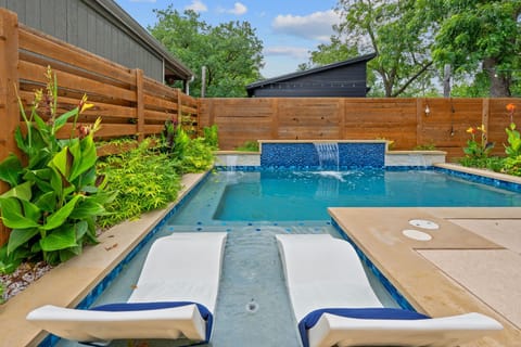 Step outside to enjoy the private fenced-in backyard, complete with outdoor seating and a sparkling pool (please note: the pool is not heated).