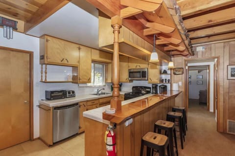 Kitchen features a breakfast bar. (Classic Lake House)