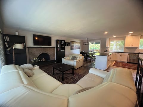 The living room with leather recliner chairs, sofa and loveseat. 