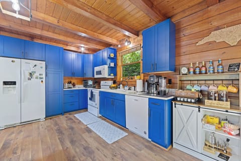 Bright cabin kitchen with bold blue cabinets and full coffee bar