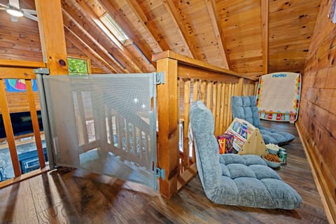Cozy loft nook with games, snacks, and plush floor seating