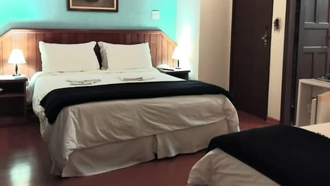 Deluxe Triple Room | Minibar, individually decorated, individually furnished, blackout drapes