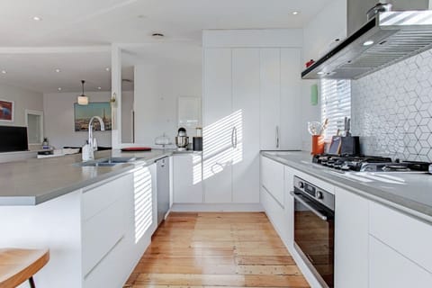 The kitchen has an oven, cooktop, microwave, dishwasher and fridge/freezer.